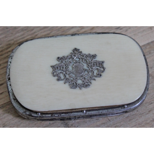 406 - A white metal mounted ivory purse.