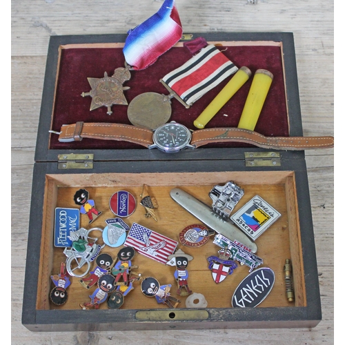 424 - A 19th Century mahogany box and contents including a Timex wristwatch, Robertsons badges, a WWI 1914... 