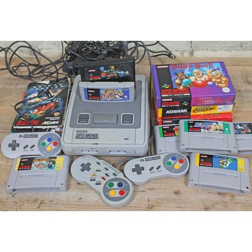 453 - A Super Nintendo Entertainment System SNES games console with two controllers and a Imagineer Game C... 