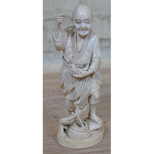 478 - A Japanese Meiji Period one piece carved ivory Okimono fisherman, signature to base, height 21cm.