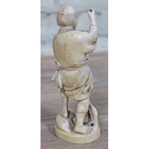 478 - A Japanese Meiji Period one piece carved ivory Okimono fisherman, signature to base, height 21cm.