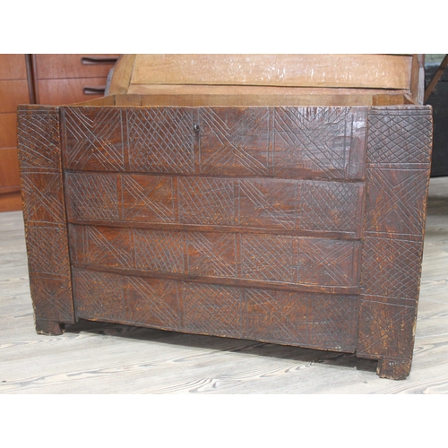 80 - A Scandinavian 17th Century golden oak coffer of carved and jointed plank construction with geometri... 