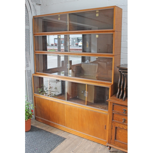 85 - A large sectional library bookcase by Simplex, width153cm, depth 36cm & height 198cm.