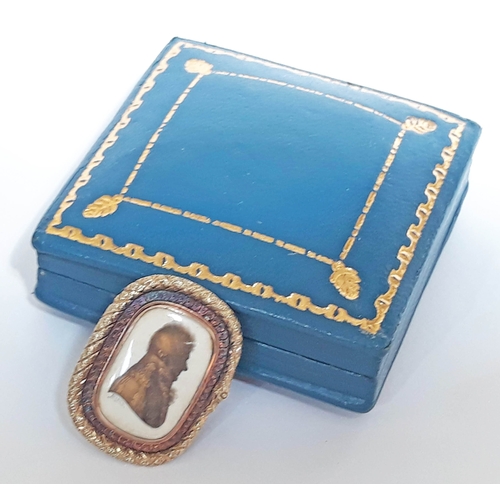 101 - A Georgian yellow metal brooch circa 1800 of rectangular form depicting a silhouette portrait of a m... 