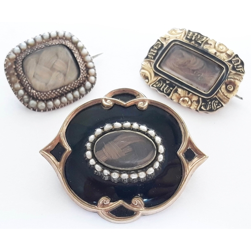 102 - A group of three 19th century yellow metal mourning brooches comprising two with plaited hair centre... 