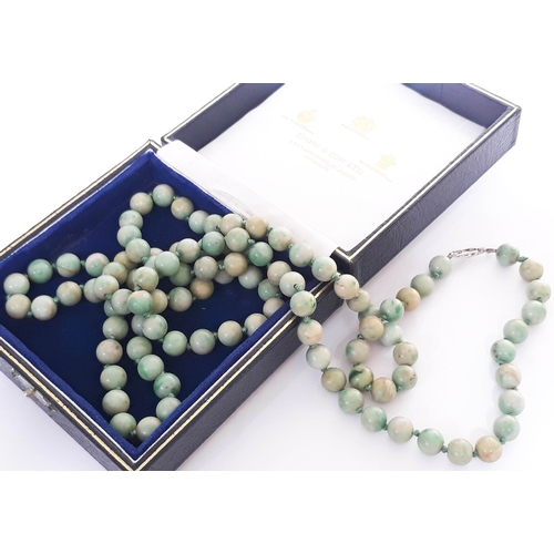 104 - A single strand of 102 jade beads with hallmarked 9 carat white gold clasp, length 112cm, bead diame... 