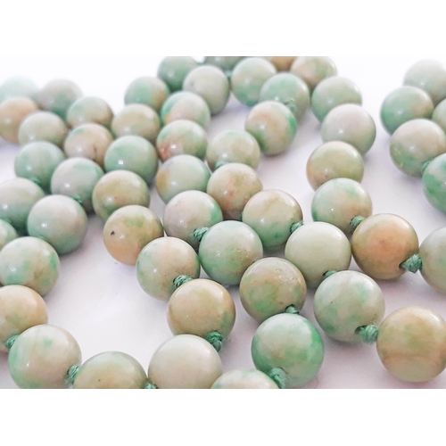 104 - A single strand of 102 jade beads with hallmarked 9 carat white gold clasp, length 112cm, bead diame... 