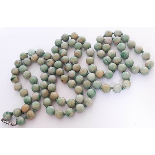 104 - A single strand of 102 jade beads with hallmarked 9 carat white gold clasp, length 112cm, bead diame... 