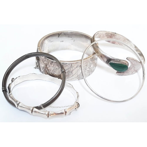 115 - A group lot of five silver bangles comprising four hallmarked silver and one marked sterling silver ... 