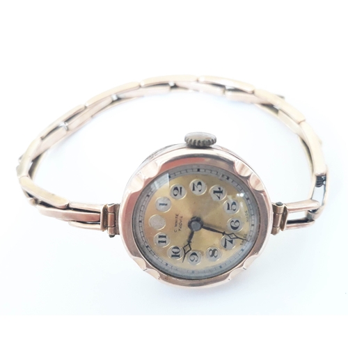 132 - A 9ct gold wristwatch with 9ct gold sprung strap, gross weight 16.3g.