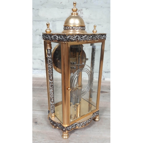 56 - A French four glass brass mantel clock with pierced folliate bands and pillars, the movement strikin... 