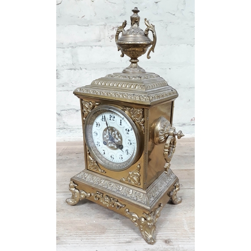 69 - A French late 19th Century gilt brass mantle clock with enamel dial, height 39cm.