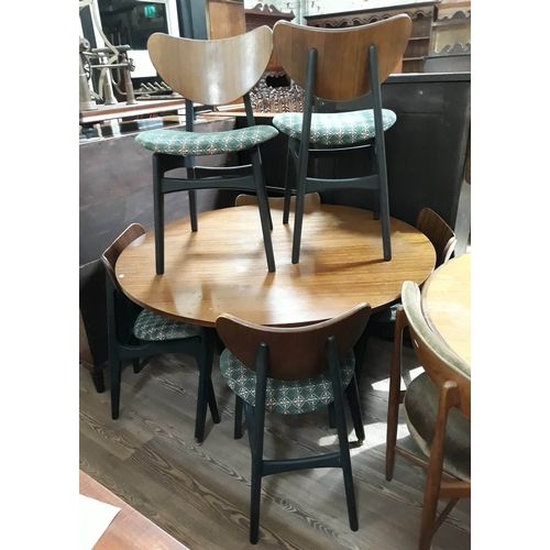 75 - A G-Plan tola and black round dining table and six chairs.