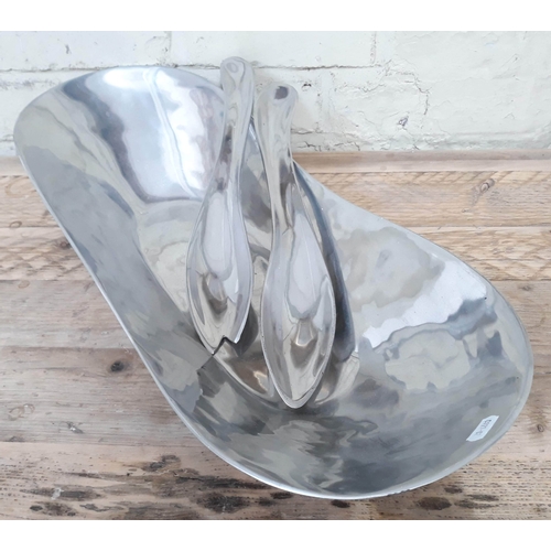 372 - A contemporary American polished metal salad bowl with servers, length 63cm.