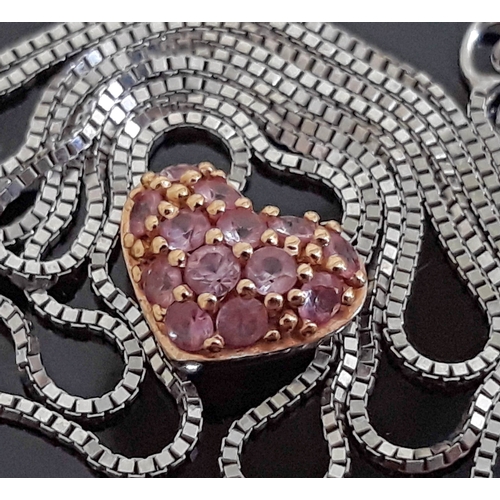 108 - A white metal heart shaped pendant set with pink tourmaline coloured stones, length 4mm, marked '14K... 