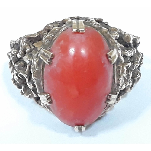 129 - A hallmarked 9ct gold ring set with a coral cabochon, gross wt. 5.7g, size N.