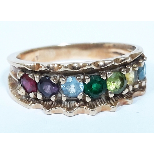 135 - A yellow metal ring set with multi-coloured gem stones, marked '10K', gross wt. 2.9g, size L.