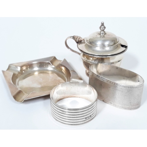 170 - Four pieces of hallmarked silver comprising a mustard, an ashtray and two napkin rings.