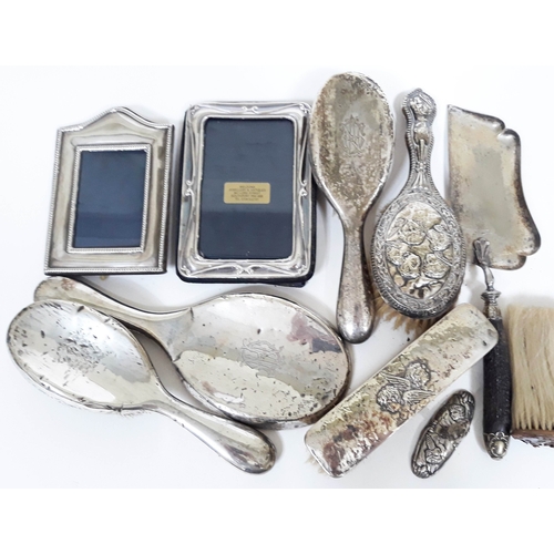 176 - A mixed lot of mainly hallmarked silver comprising two photo frames, silver backed mirror, four silv... 