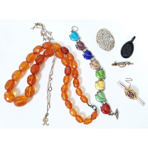 181 - A mixed lot of jewellery comprising an facetted amber bead necklace, a a hallmarked silver and ename... 