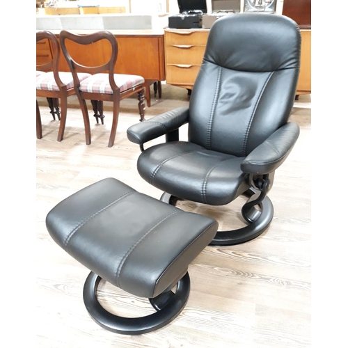 27 - An Ekornes Stressless Consul black leather reclining armchair and stool, height 98cm, width 73cm, de... 