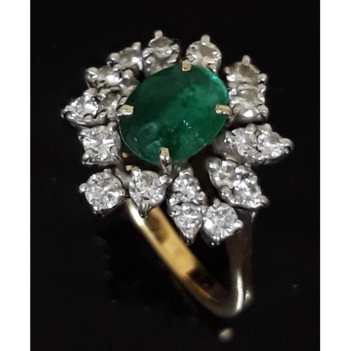 184 - An emerald and diamond cluster ring, the central stone measuring 7mm x 5mm x 3mm, 18ct gold import m... 