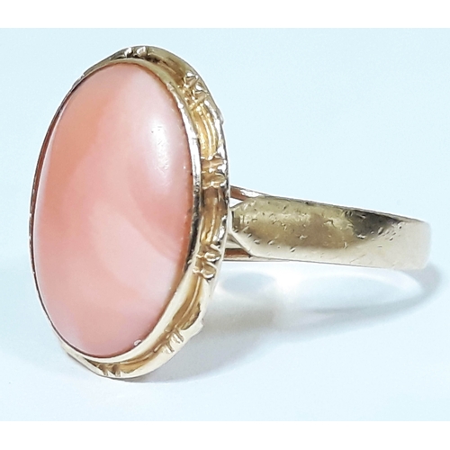 189 - A hallmarked 14ct gold coral cabochon ring, the coral measuring approx. 15mm x 11mm x 3mm, gross wt.... 