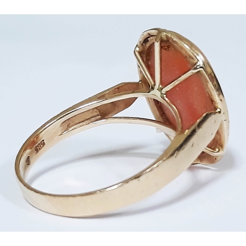 189 - A hallmarked 14ct gold coral cabochon ring, the coral measuring approx. 15mm x 11mm x 3mm, gross wt.... 