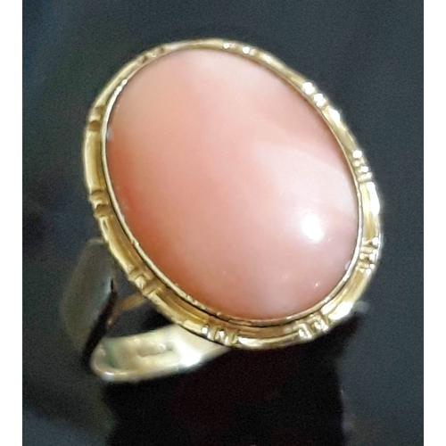 189 - A hallmarked 14ct gold coral cabochon ring, the coral measuring approx. 15mm x 11mm x 3mm, gross wt.... 