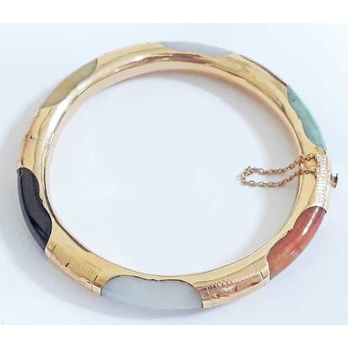 194 - A Chinese 14K multi-coloured jade bangle, marked '14K' & 585', diam. 7cm, wt. 27g.