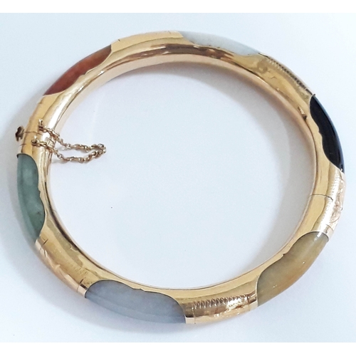 194 - A Chinese 14K multi-coloured jade bangle, marked '14K' & 585', diam. 7cm, wt. 27g.