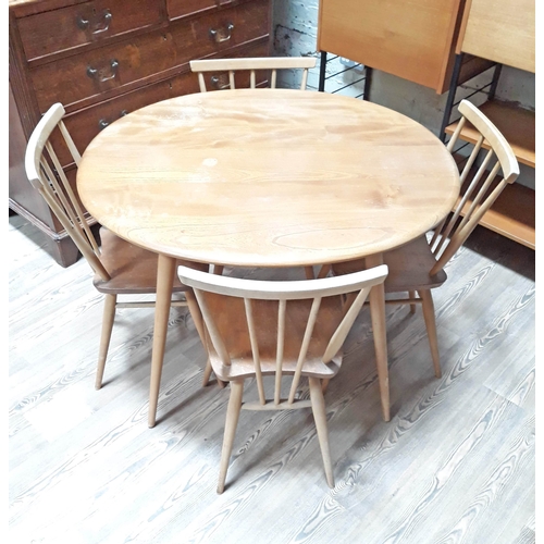 66 - An Ercol light elm and beech oval dining table with lower spindle tier and four chairs.