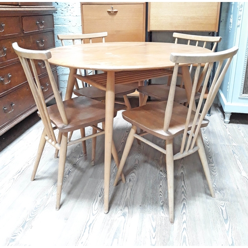 66 - An Ercol light elm and beech oval dining table with lower spindle tier and four chairs.