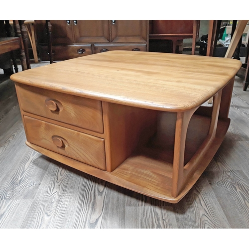 68 - An Ercol light elm and beech coffee table with two drawers.