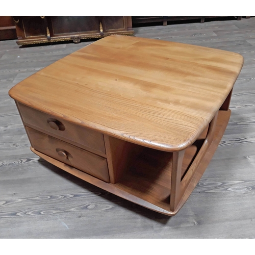 68 - An Ercol light elm and beech coffee table with two drawers.