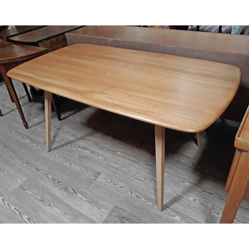 69 - An Ercol blonde elm and beech dining table.