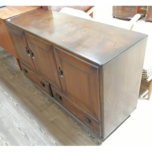 78 - An Ercol dark elm Windsor sideboard with 3 cupboards over 2 drawers, height 76cm, width 130cm, depth... 