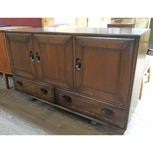 78 - An Ercol dark elm Windsor sideboard with 3 cupboards over 2 drawers, height 76cm, width 130cm, depth... 