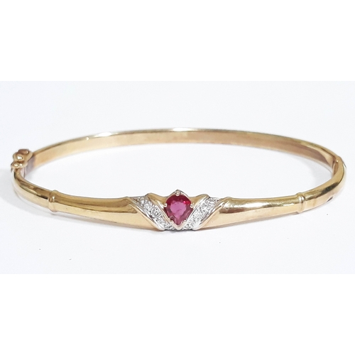 200 - A 9ct gold diamond and ruby bangle, diam. 5.5cm, gross wt. 5.8g.