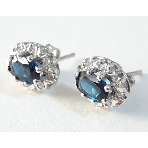 391 - A pair of hallmarked 18ct white gold diamond and sapphire ear studs, gross wt. 3g.