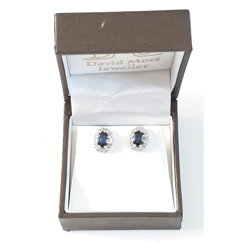 391 - A pair of hallmarked 18ct white gold diamond and sapphire ear studs, gross wt. 3g.