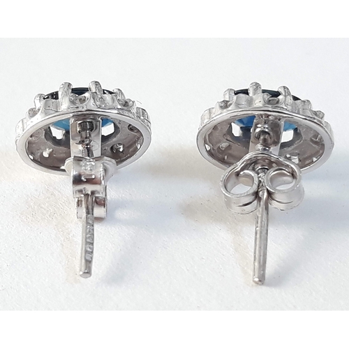 391 - A pair of hallmarked 18ct white gold diamond and sapphire ear studs, gross wt. 3g.