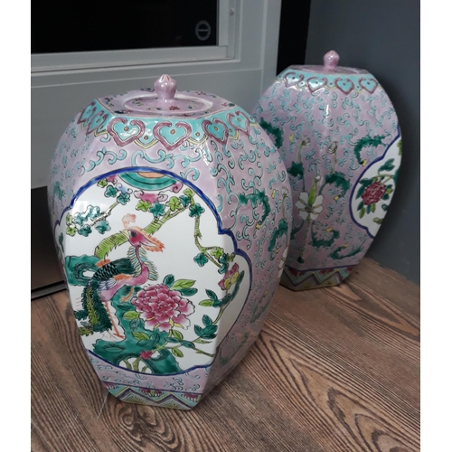 437 - A pair of Chinese porcelain jars of hexagonal form with covers, red seal to base, height 30cm.