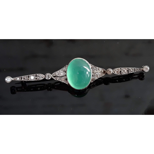 103 - An Art Deco diamond encrusted and jade cabochon brooch, the central stone approx. 19mm x 11mm x 6mm,... 