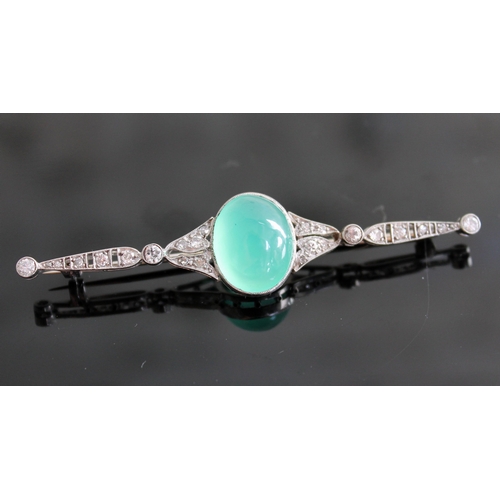 103 - An Art Deco diamond encrusted and jade cabochon brooch, the central stone approx. 19mm x 11mm x 6mm,... 