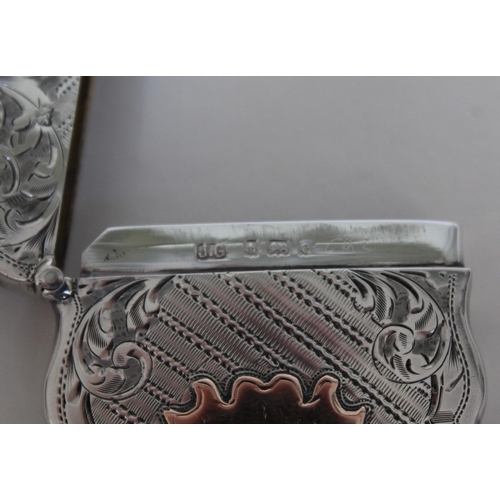 112 - An Edwardian silver card case of shaped form, bright cut engraved and having gold cartouche, Joseph ... 