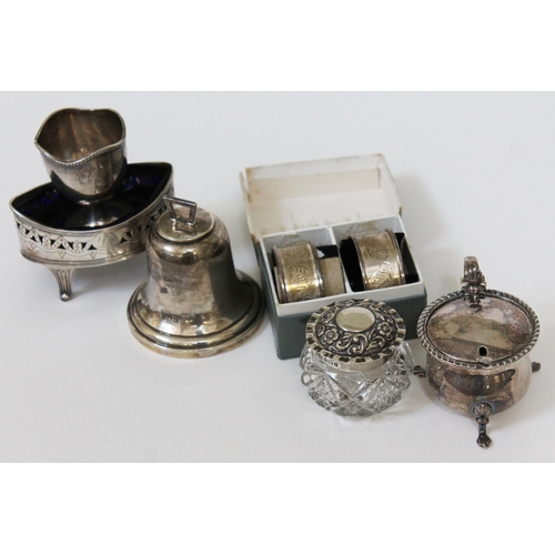 118 - Six items of hallmarked silver comprising a blue glass lined salt, an egg cup, a novelty bell, a pai... 