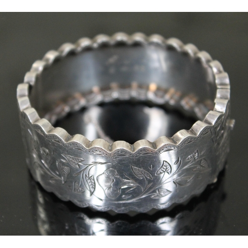 142 - A hallmarked silver hinge bangle with engraved decoration to top section, diameter 6.2cm.