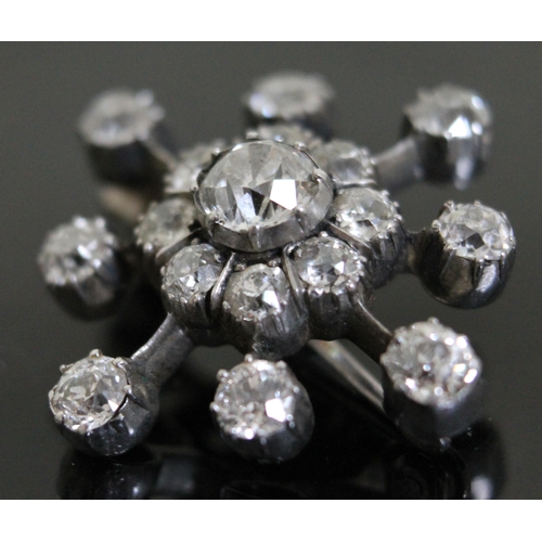 156 - A diamond star cluster brooch, crafted in white metal, unmarked, the central old cut diamond approx.... 