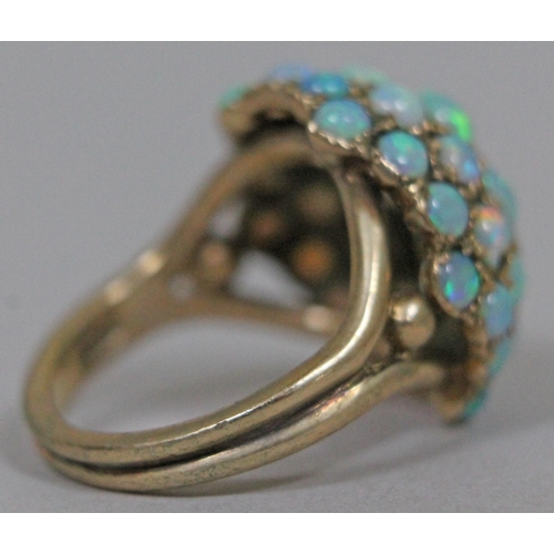 173 - An opal cabochon cluster ring, hallmarked 9ct gold band and setting, gross wt. 6.9g.